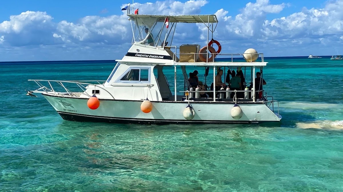 The Careyitos Divers boat anchored over clear turquoise water off Cozumel with divers aboard
