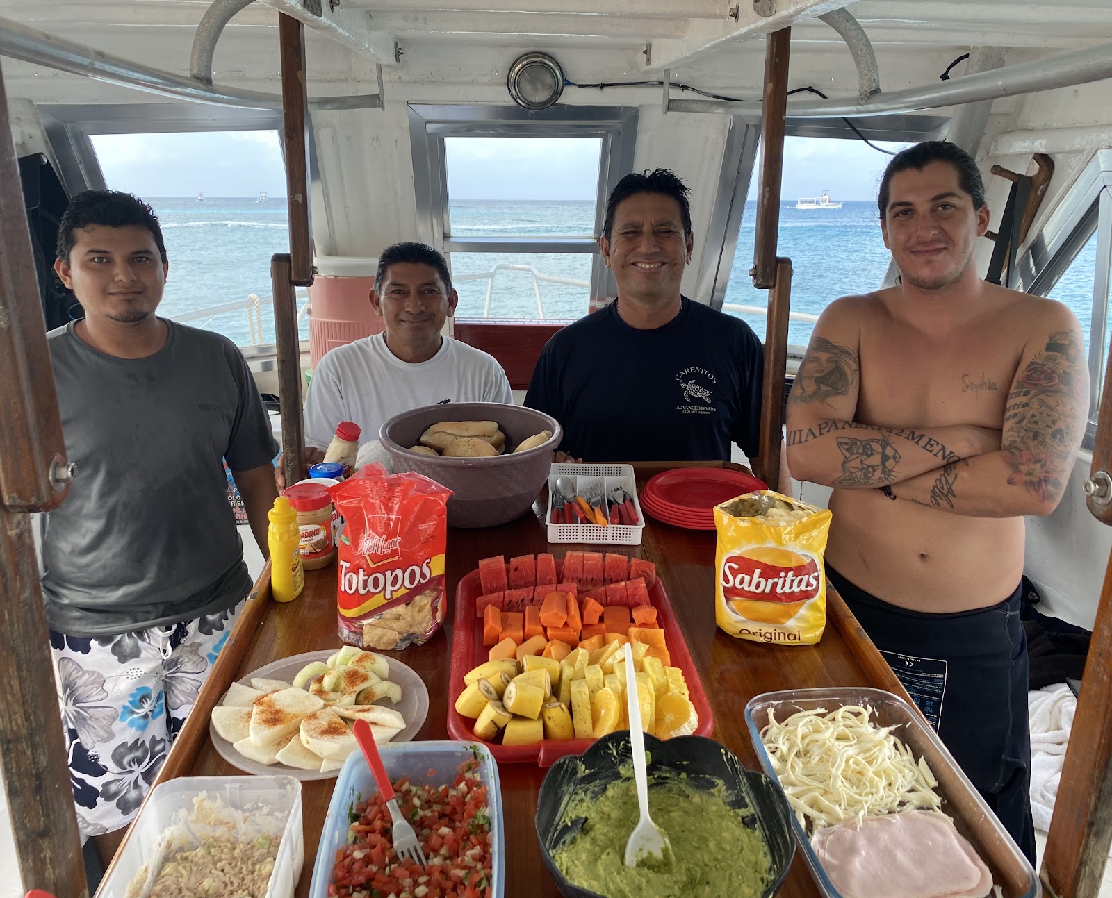Careyitos crew members on the back deck of the boat in Cozumel